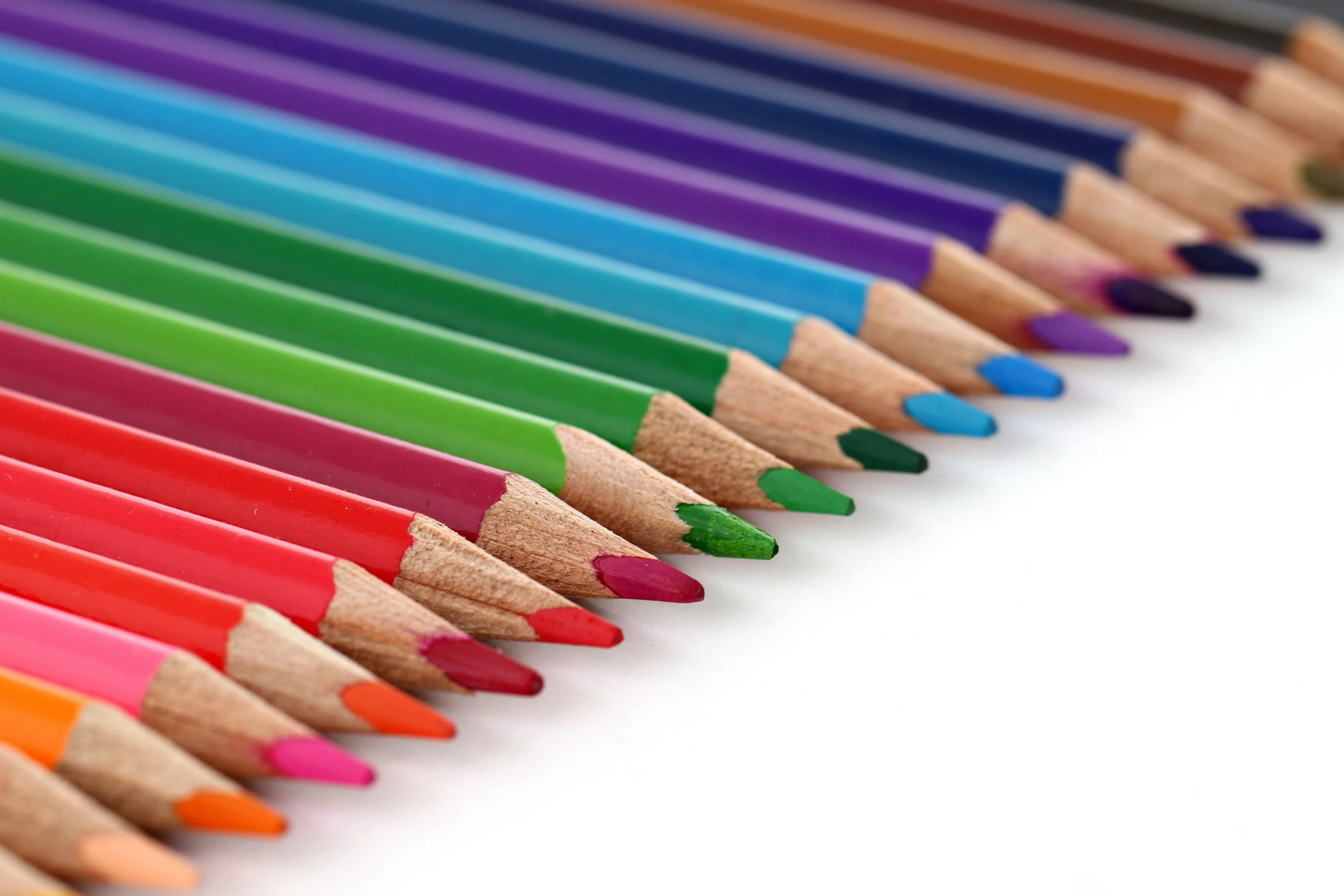 a line of colored pencils sitting on top of each other