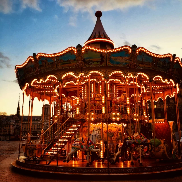 a merry go round ride with lights on it