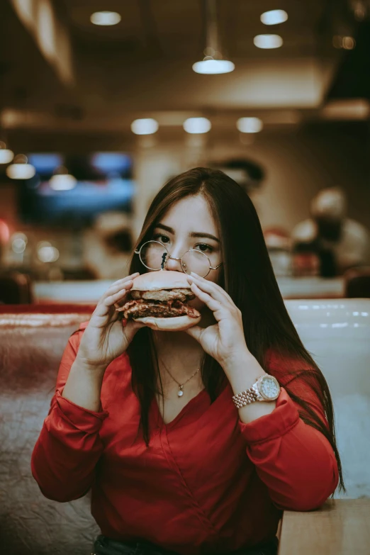 a woman holding up a piece of food to her mouth