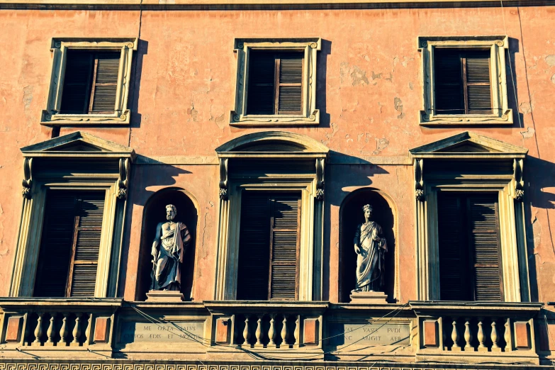 statue statues on the ledges of the windows of a building