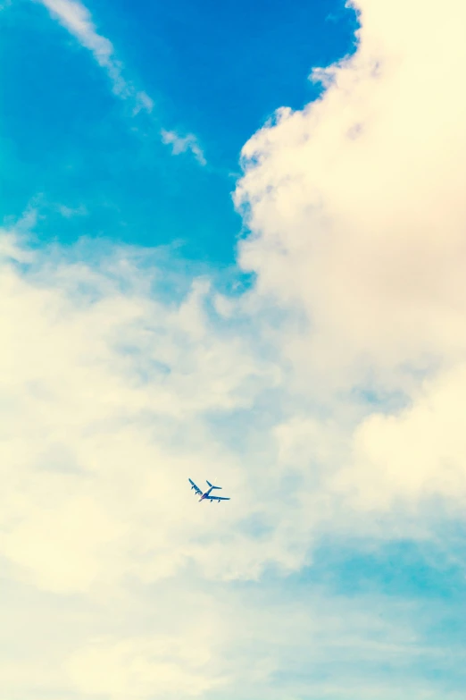 an airplane is flying through the sky and clouds