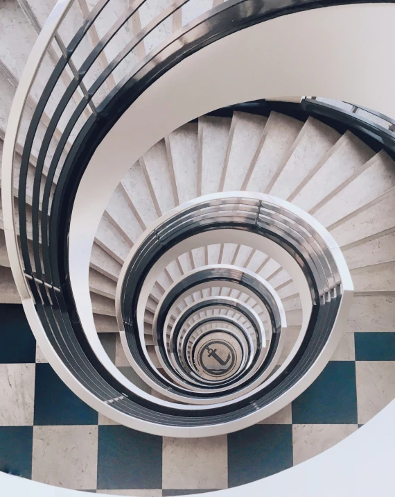 the spiral staircase inside a building is painted in black and white