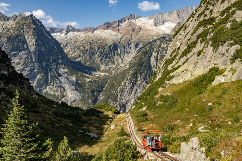 the train rides through the mountains near the trail