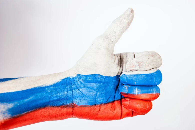 a persons hand is painted in the colors of the russian flag