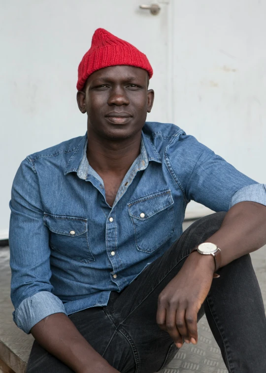 a person is wearing a red hat and sitting down