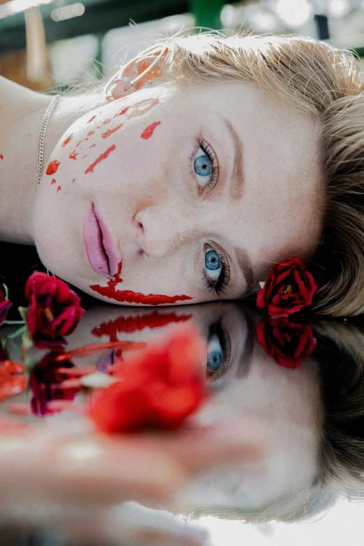 a woman in makeup and a rose is laying down