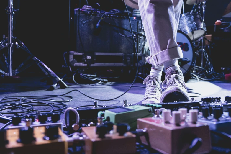 a person on stage wearing all white with lots of lights