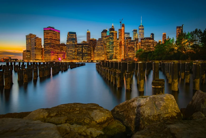 city in the distance and its bright lights reflect off the water