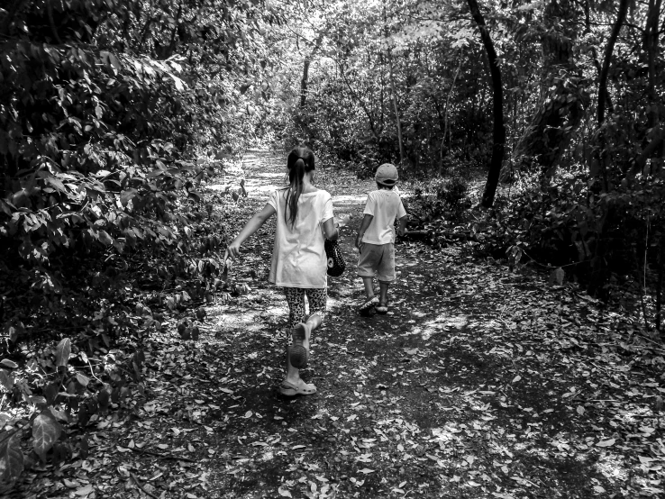 two children playing in the woods on a rainy day