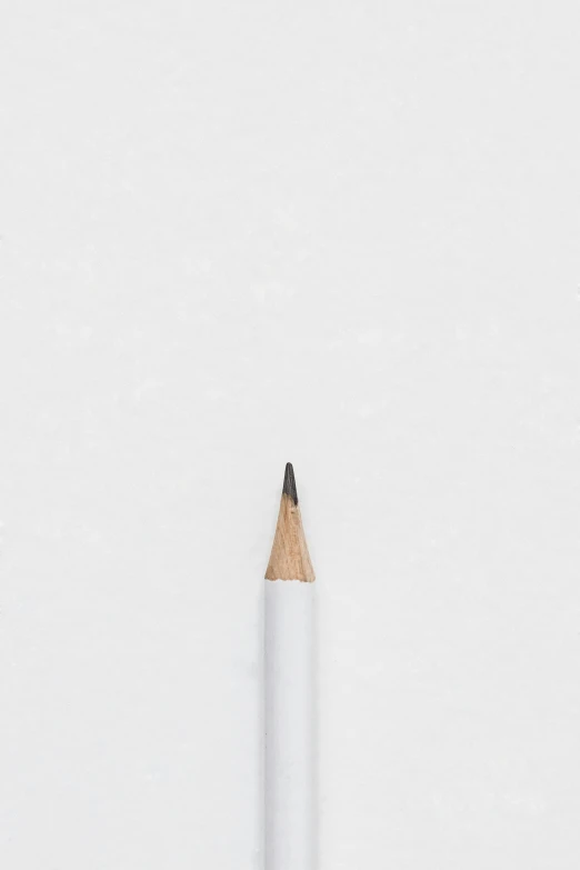 a pencil and a piece of paper sitting in the snow