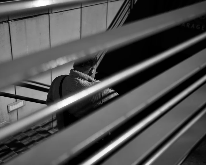 woman in top of row of benches looking down at soing