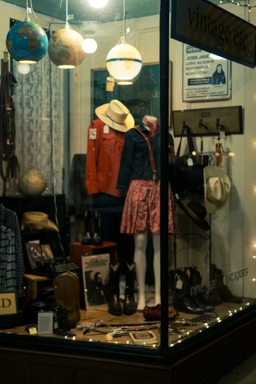 a man and woman in front of window display with lots of clothes