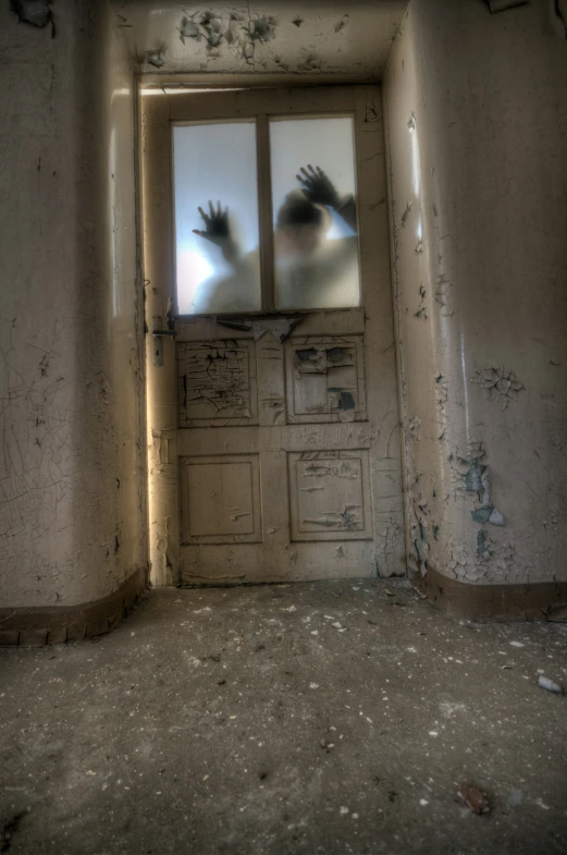 a ghostly image of a door with two hands above it