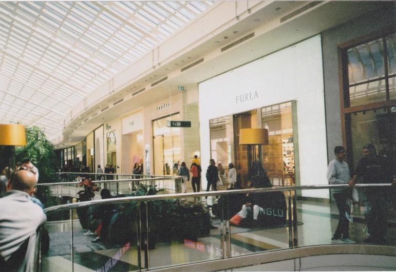 an image of people on their cell phones at the mall