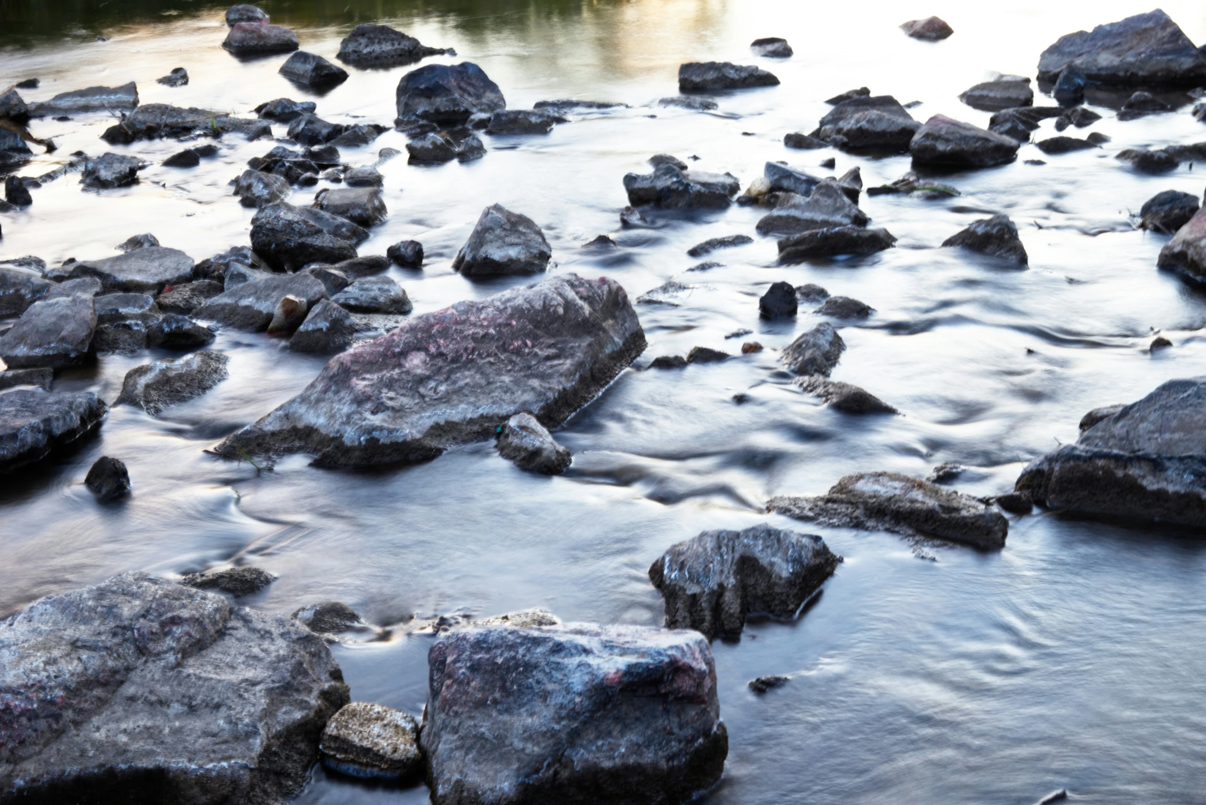 water and rocks flowing through a large river