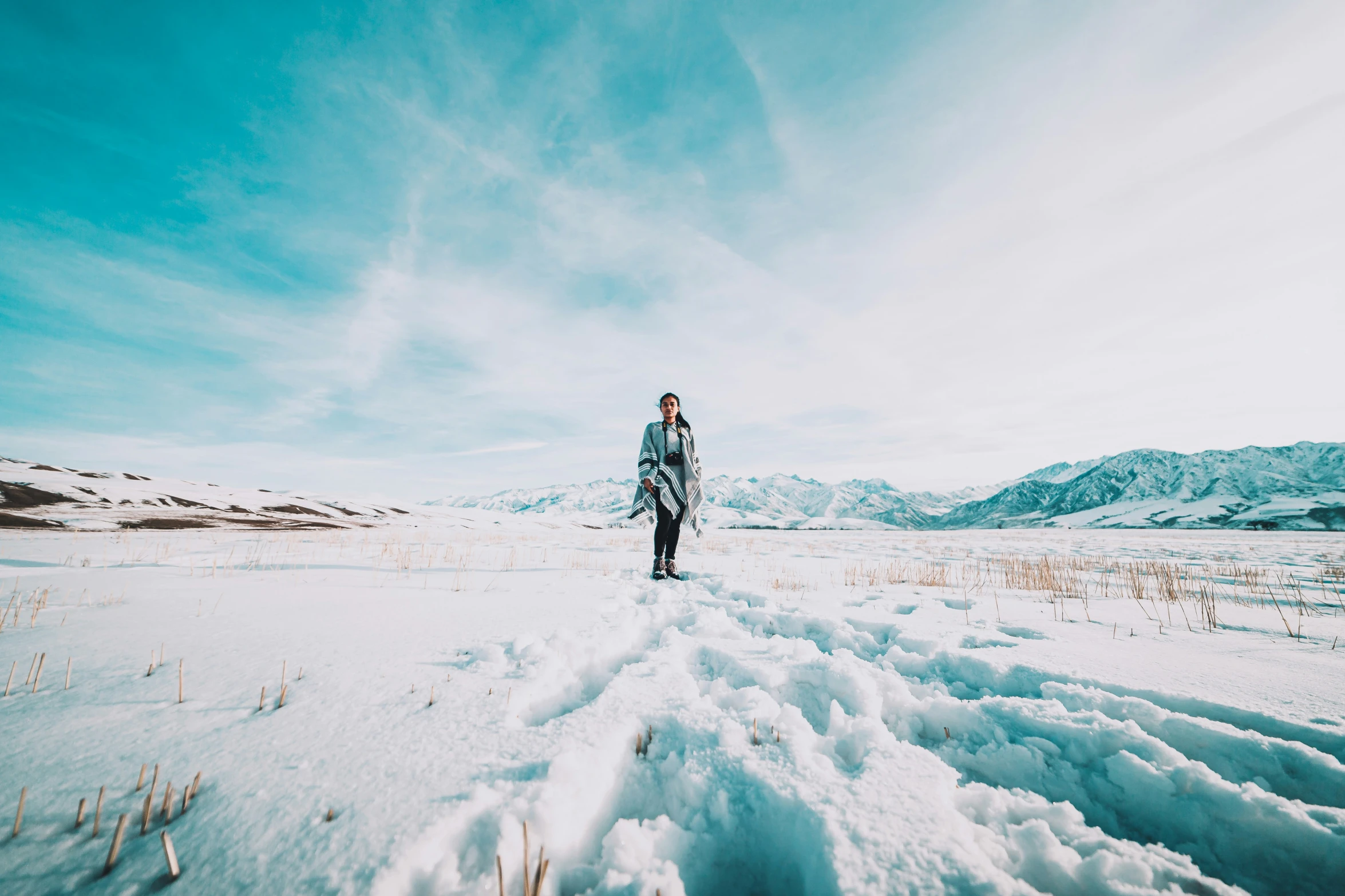 a person walking through a field covered in snow