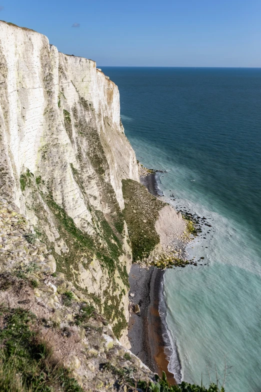 a very large cliff overlooking a body of water