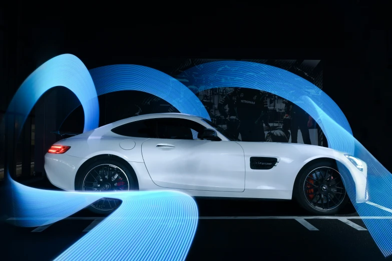 the mercedes sls amg coupe sits in front of a wall