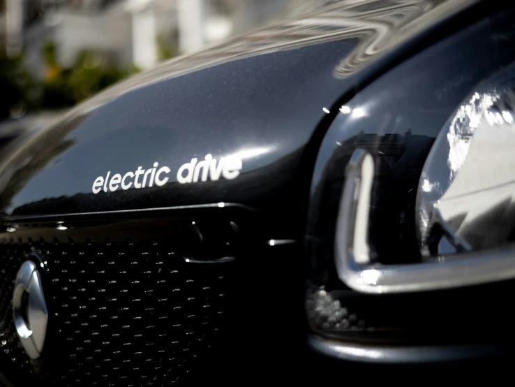 the back end of a black vintage electric drive car