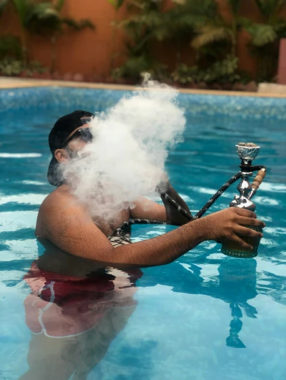 a man sitting in the water smokes a pipe