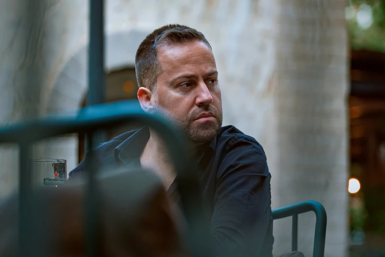 a man is sitting outside in the sun