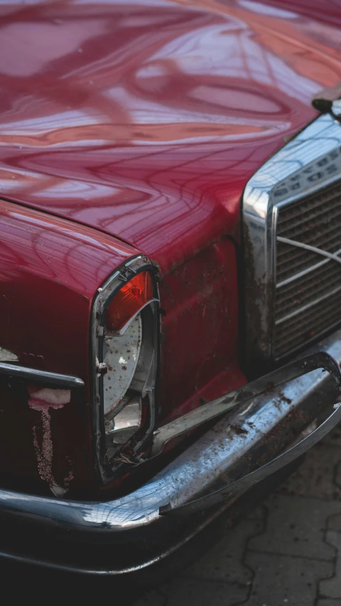 a close up of the grill of a red classic car