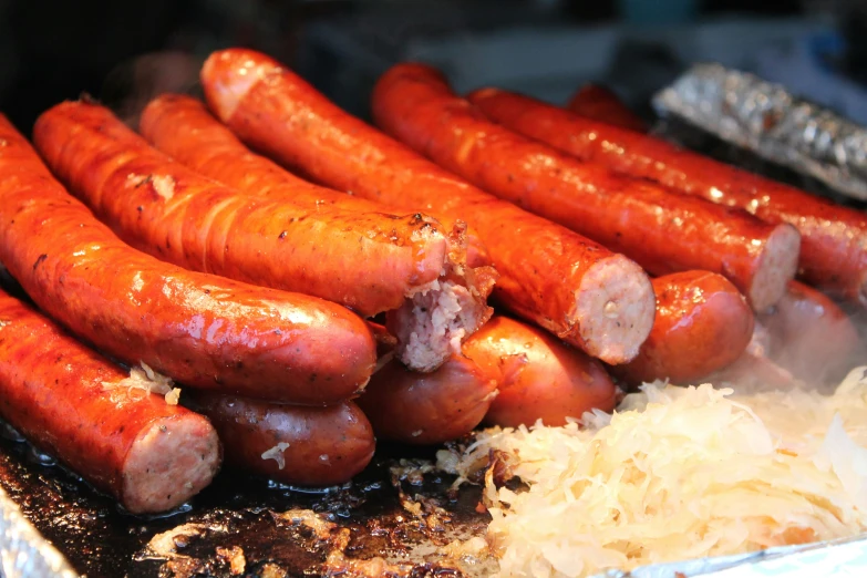 four rows of cooked sausages on a grill