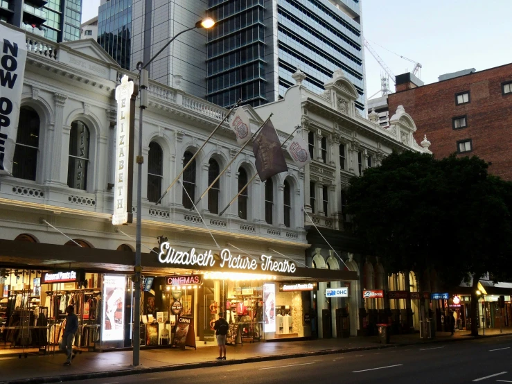 a busy city street with a very old looking business