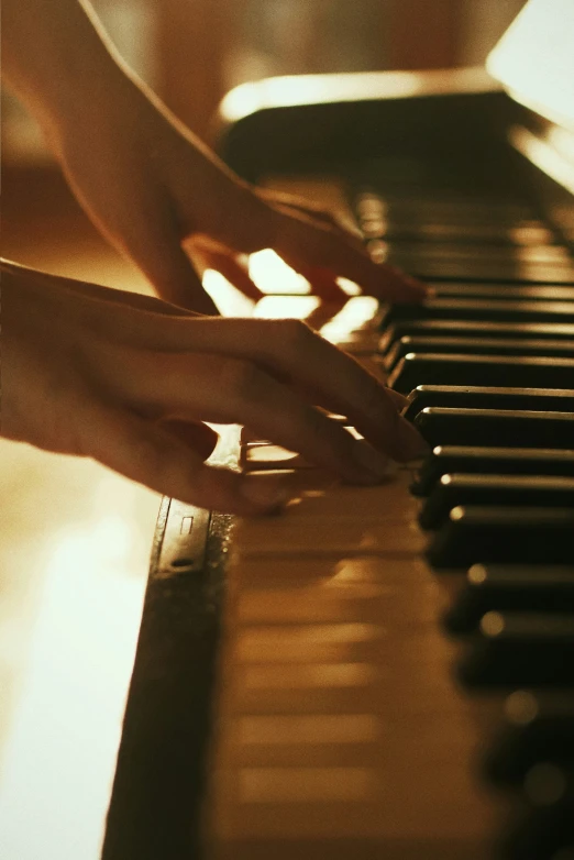 someone is playing the piano in a dimly lit room