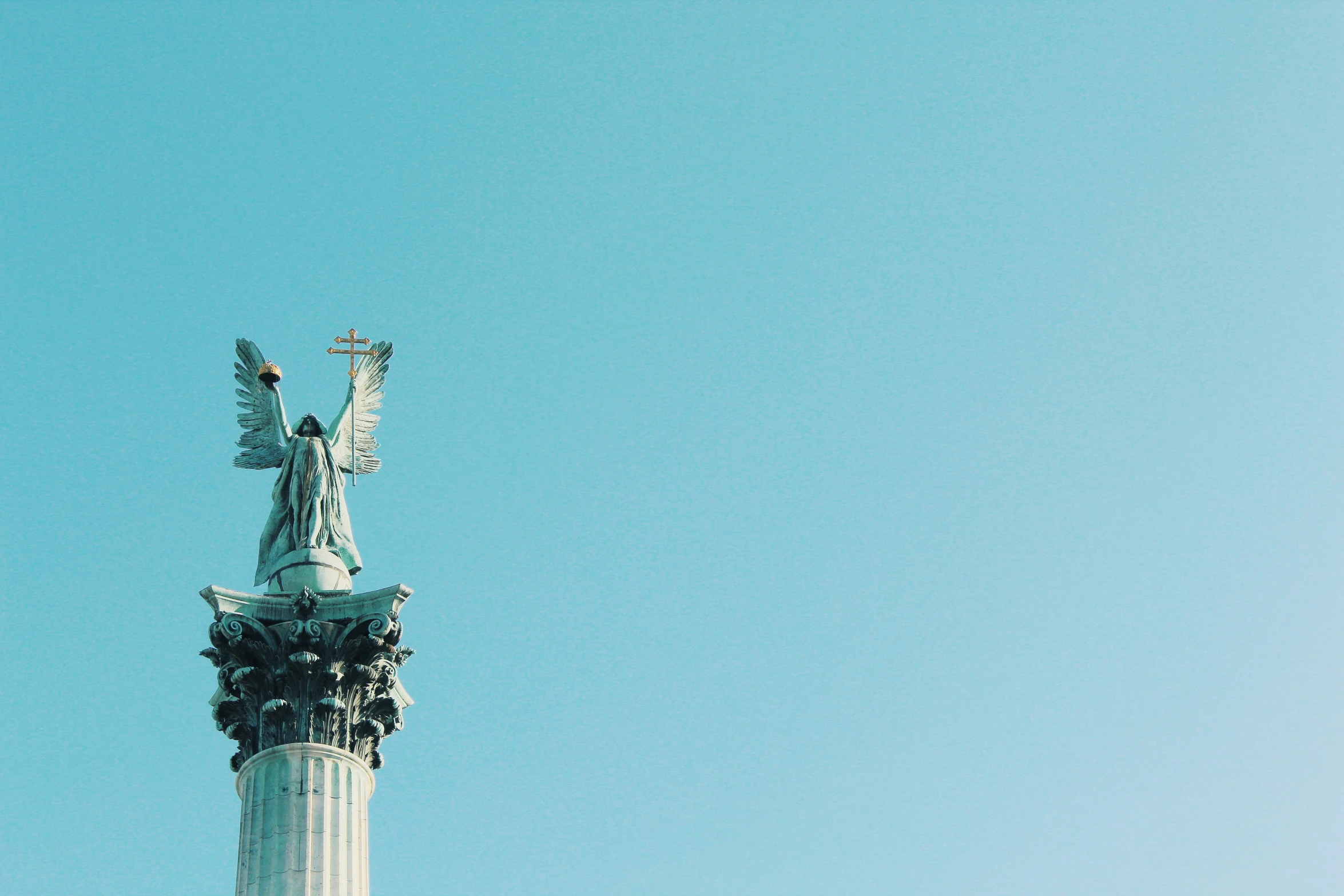 the view of the base of a monument with a bird flying over it