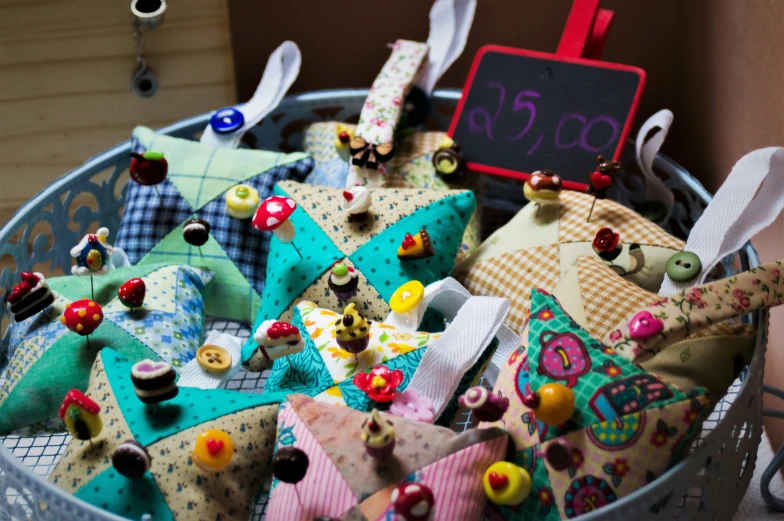 a basket of fabric has a clock, scissors and pins