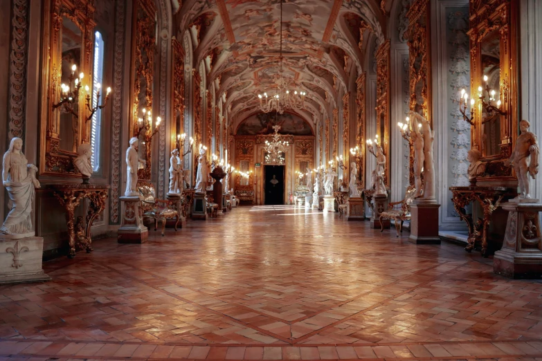 a building with arches and chandeliers and a large floor