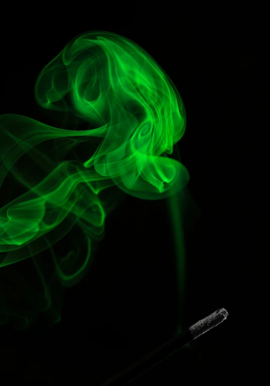green smoke sticks against a black background