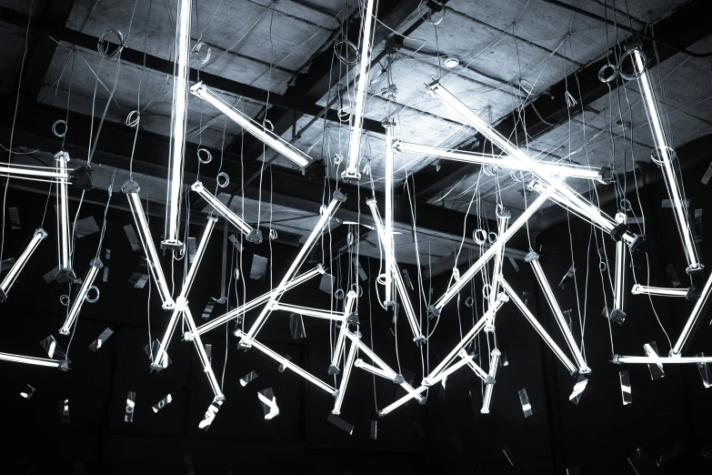 an illuminated ceiling with hanging lights