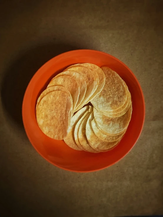sliced bread on top of a orange bowl