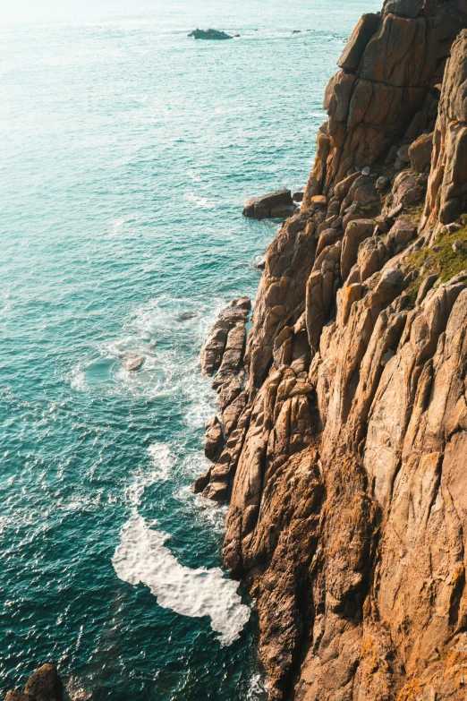 a rocky beach next to a body of water