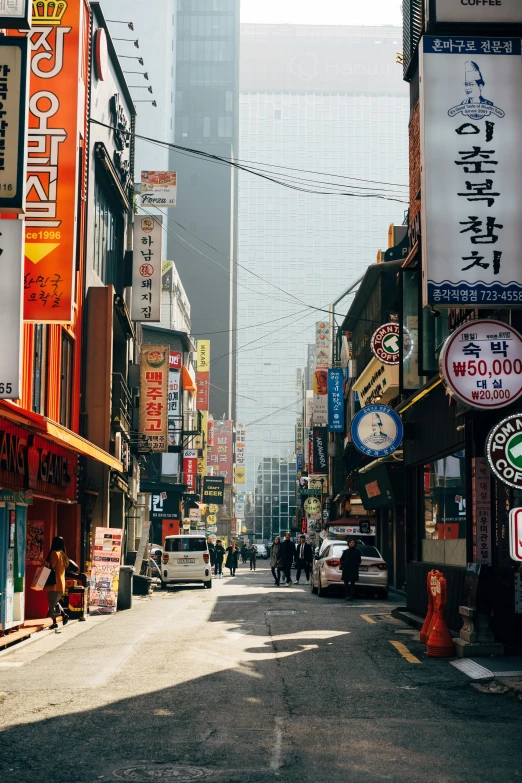 a city street filled with lots of people and stores