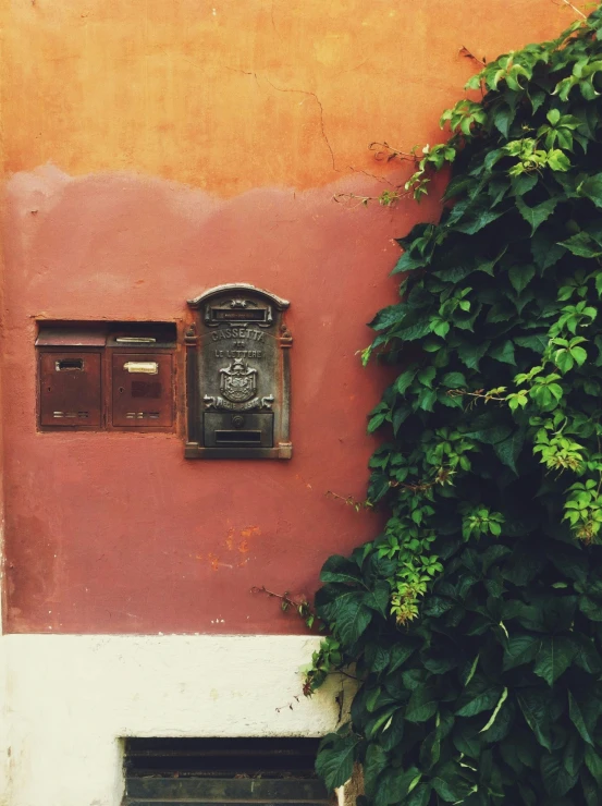 two windows on the side of a red building