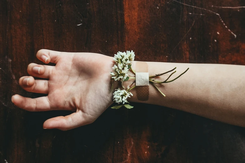 someone holds a hand with a piece of cloth that has flowers on it