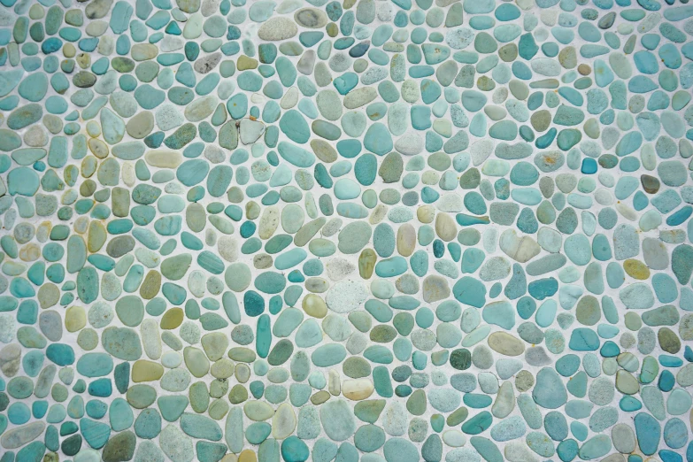 the colorful pebbles on the surface appear to be in shades of green