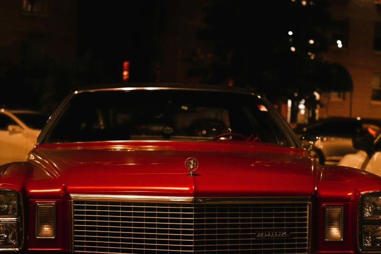 a red car is sitting on the curb