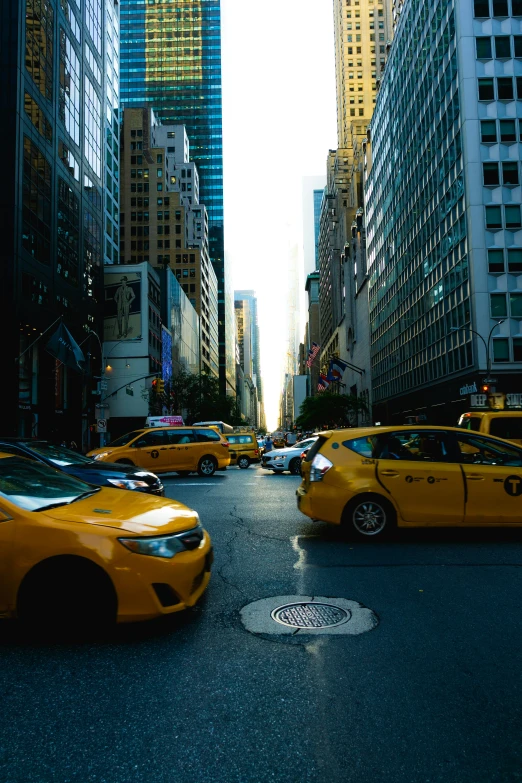 a street filled with cars and people riding on the back of it