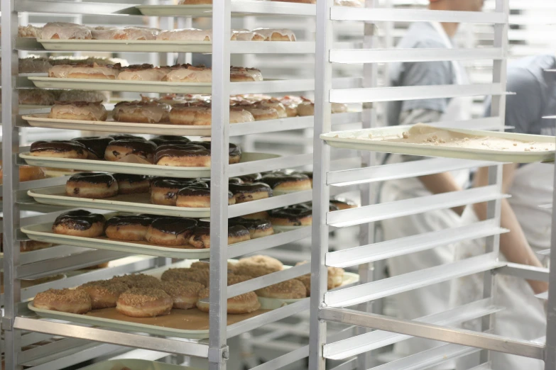 a baker taking pastries out of the oven in a bakery