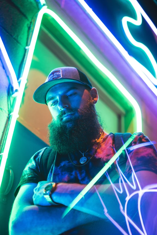 a man with a beard and a cap posing for a picture