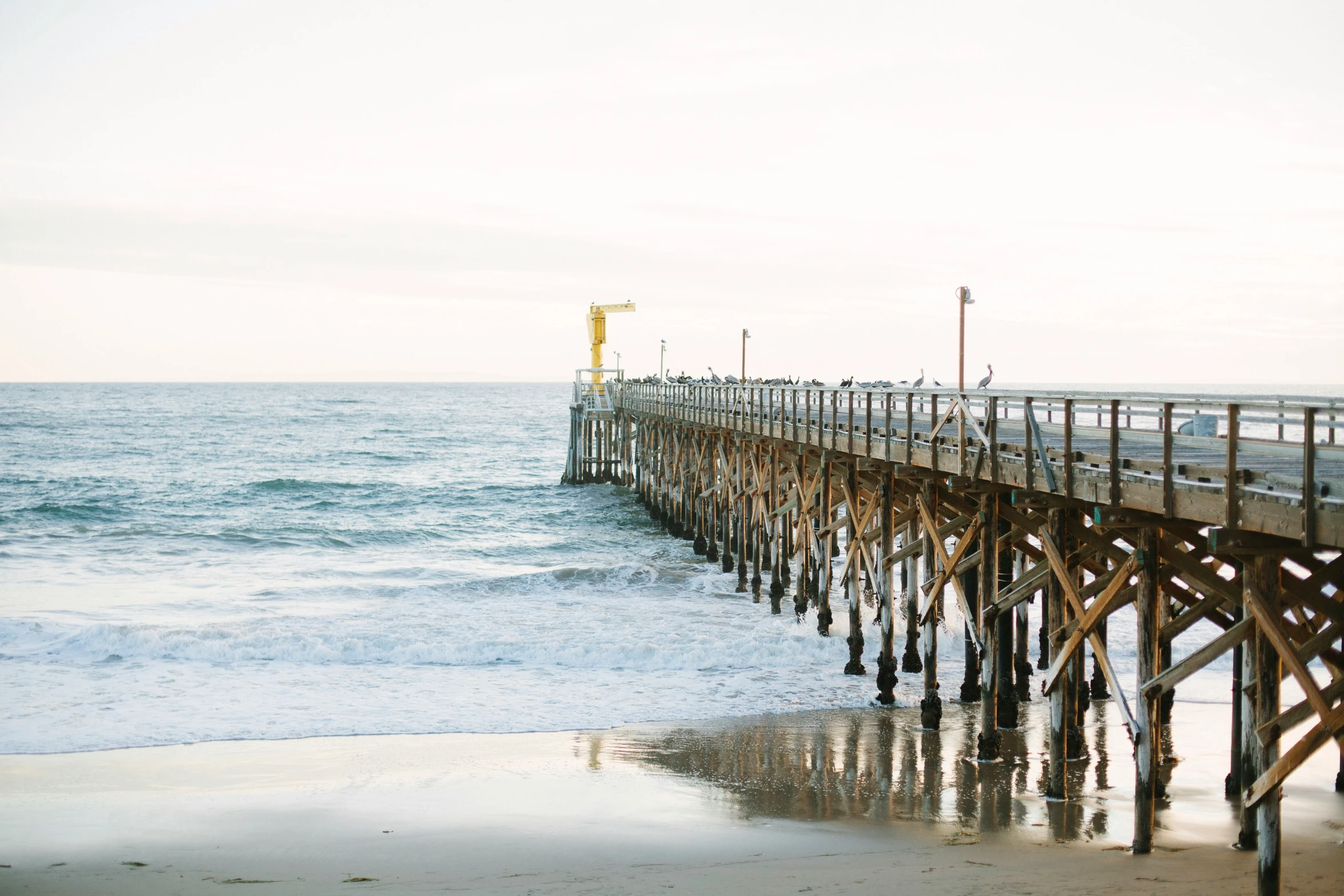 a pier next to the ocean on a cloudy day