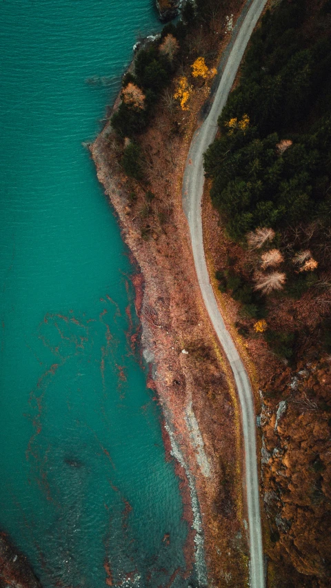 the aerial s shows water and a narrow road