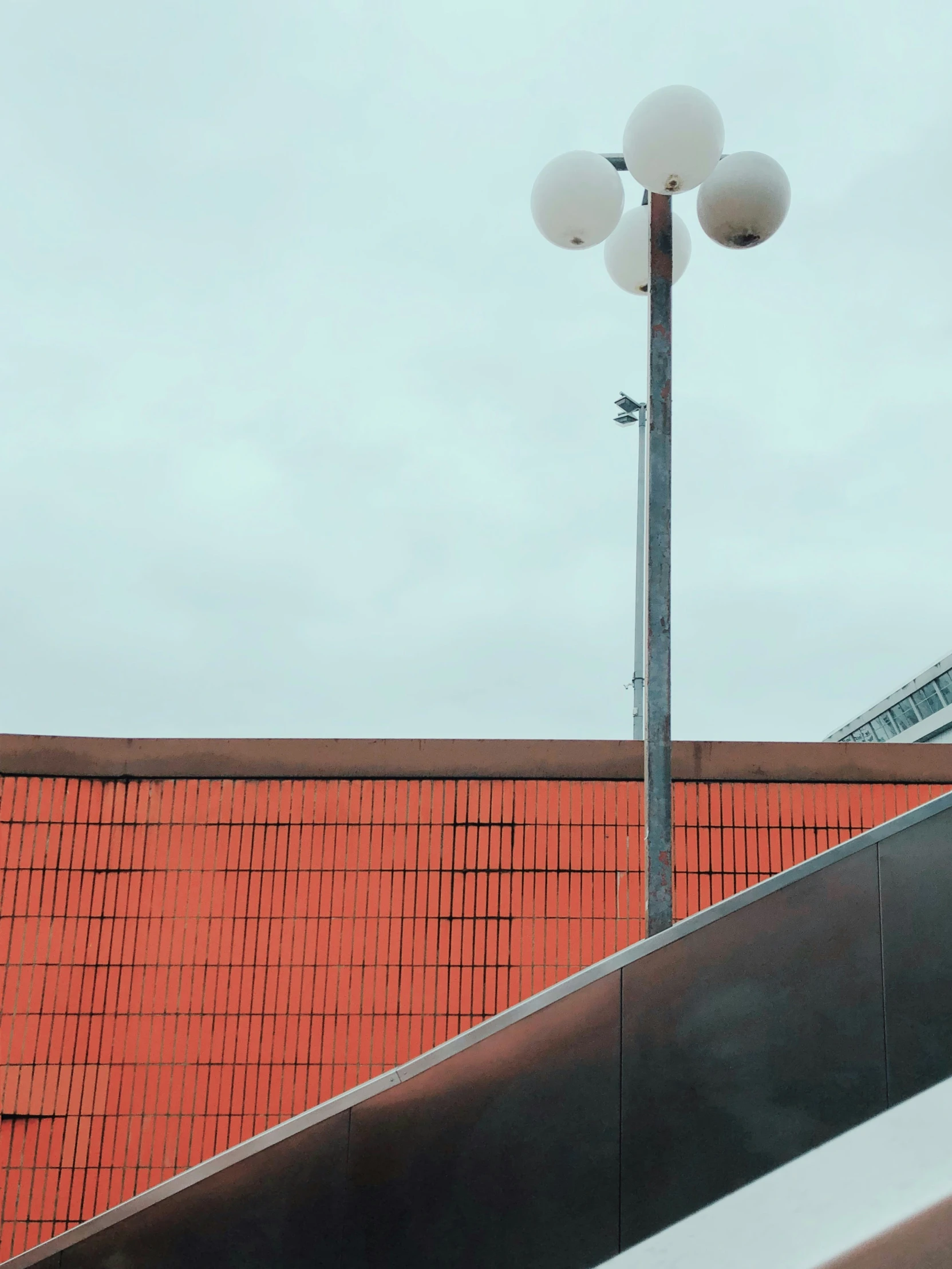 stairs and street lights along a brick wall