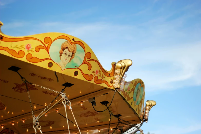 an ornate merry go round tent with a blue sky background