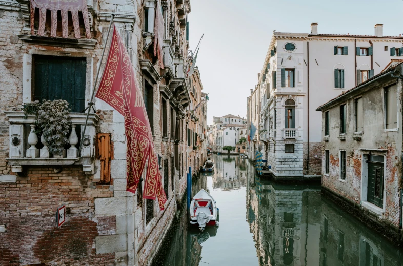 a waterway with buildings and an arrow flag