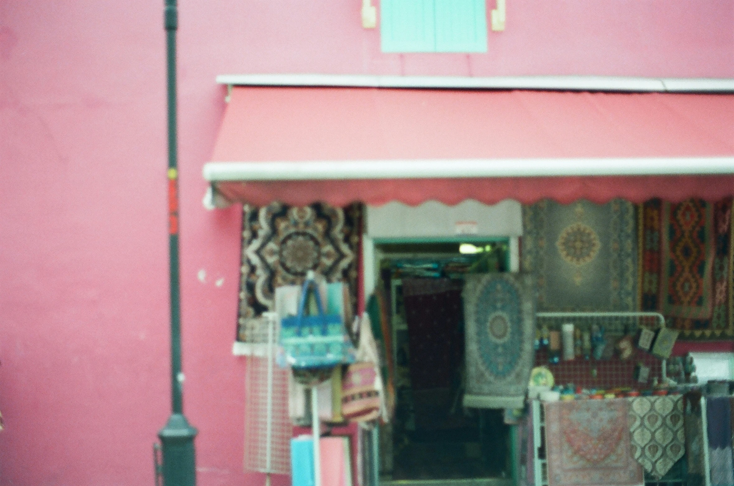 a red building with a canopy near a street light